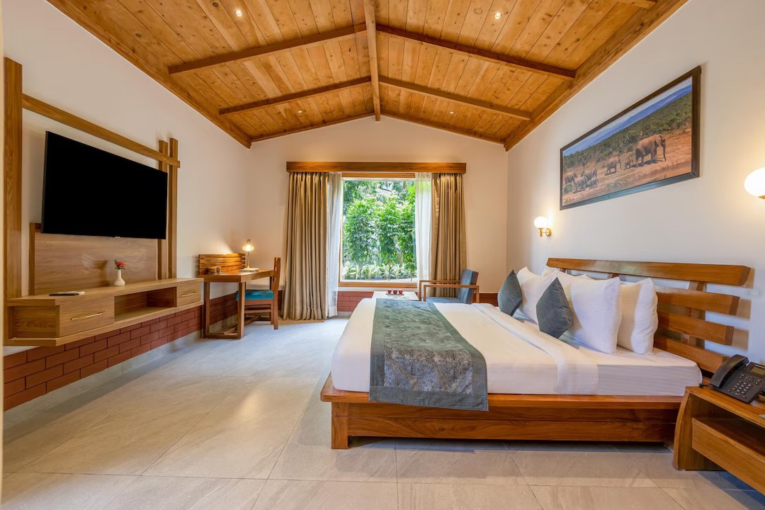 A guest room with a wooden ceiling and a garden window